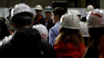 Prime Minister Justin Trudeau speaks with workers at the ArcelorMittal Dofasco plant