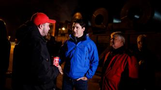 Prime Minister Justin Trudeau and MP Terry Sheehan speak with an Algoma steel worker outside the Direct Strip Production Complex