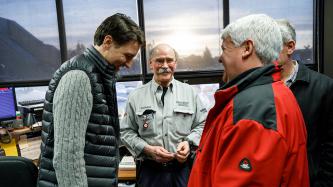 Prime Minister Justin Trudeau and MP Terry Sheehan share a laugh with Algoma steel workers in an office of the Direct Strip Production Complex