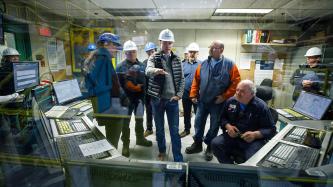 Prime Minister Justin Trudeau gestures during a conversation in the control room of Algoma’s Direct Strip Production Complex alongside MP Terry Sheehan and several steel workers