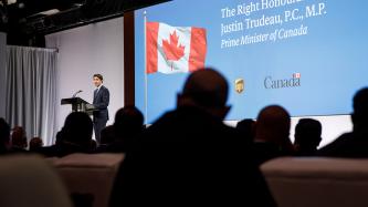 Prime Minister Justin Trudeau addresses the audience from a podium on stage at the 2018 UPS Management Conference.
