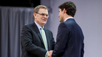 Prime Minister Justin Trudeau shakes hands with David Abney, CEO of UPS.