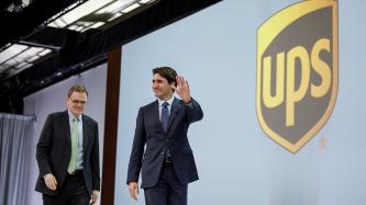 Prime Minister Justin Trudeau waves to the audience while leaving the stage at the 2018 UPS Management Conference.