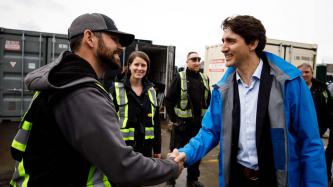 PM Trudeau shakes hands with a man