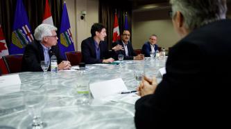 Prime Minister Justin Trudeau speaks during a meeting with energy sector leaders while Minister Amarjeet Sohi and Minister James Gordon Carr look on