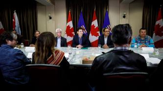 Prime Minister Justin Trudeau, Minister Amarjeet Sohi and Minister James Gordon Carr sit and listen during a meeting with members of First Nation communities