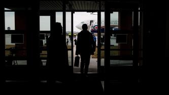 PM Trudeau walks out a door towards a plane