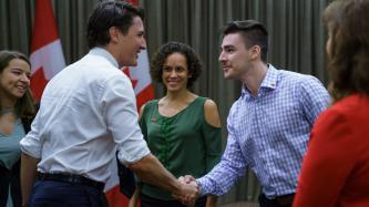 Prime Minister Justin Trudeau shakes hands with one of the Canadian youth delegates to the Young Americas Forum