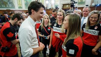 Prime Minister Justin Trudeau speaks with a group of Canadian Olympians and Paralympians in Parliament