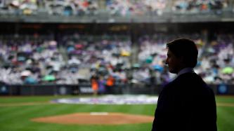Prime Minister Justin Trudeau stands on the field at Yankee Stadium