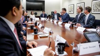 Prime Minister Justin Trudeau speaks during a roundtable meeting with over a dozen others at BlackRock