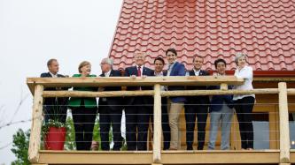 The G7 Leaders have their pictures taken on an elevated deck.