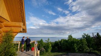 PM Trudeau talks with President Donald Trump on an elevated deck.