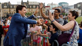 PM Trudeau high fives a group of attendees