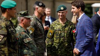 PM Trudeau speaks with Canadian military member