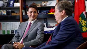 Prime Minister Justin Trudeau sits with Toronto Mayor John Tory.