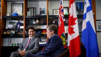 Prime Minister Justin Trudeau sits with Toronto Mayor John Tory.