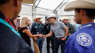 Prime Minister Justin Trudeau greets a woman at the Calgary Stampede.