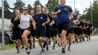 Minister Freeland runs with troops