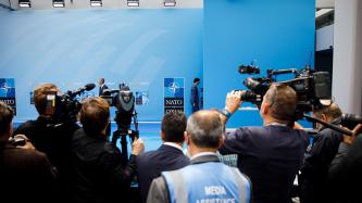 The media take photos of the Prime Minister on his arrival.