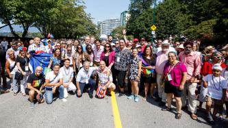 PM Trudeau poses with a large crowd in a street