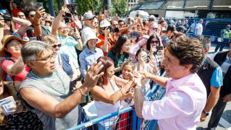 PM Trudeau shakes hands with people in a crowd