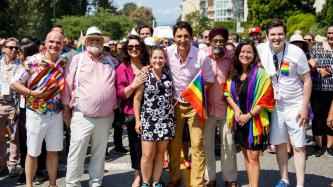PM Trudeau poses with a large crowd in a street