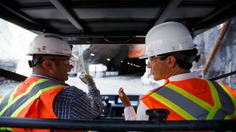 PM Trudeau accompanies a worker in an ATV