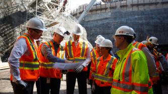 PM Trudeau looks at the plans of the construction site