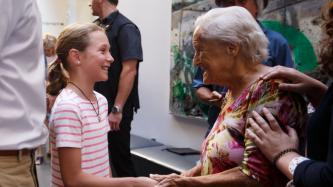 Ella-Grace shakes hands with an elderly woman
