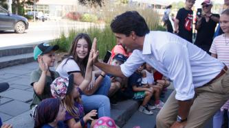 PM Trudeau high fives a group of children