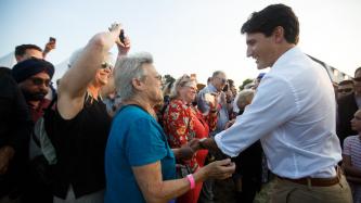 PM Trudeau shakes hands with a group of people