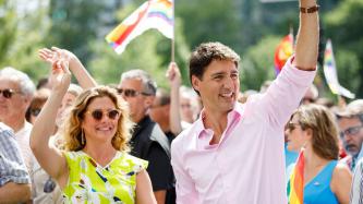 PM Trudeau and Sophie smile and wave to the crowd