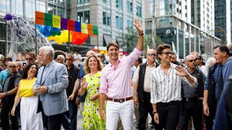 PM Trudeau and Sophie smile and wave to the crowd
