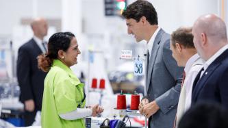 PM Trudeau speaks with a factory worker