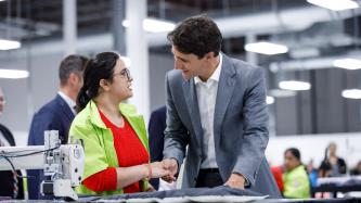 PM Trudeau shakes hands with a factory worker