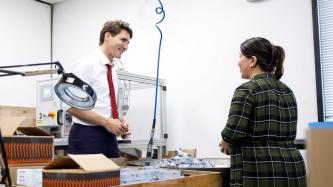 PM Trudeau listens to an entrepreneur
