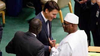 PM Trudeau listens to a man speak