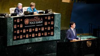 PM Trudeau speaks at the podium during the Mandela Peace Summit