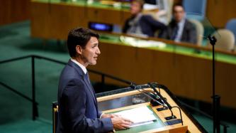 PM Trudeau speaks at the podium during the summit