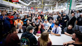PM Trudeau and Minister Hajdu sit with a group of employees
