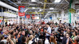 PM Trudeau stands and speaks to the crowd