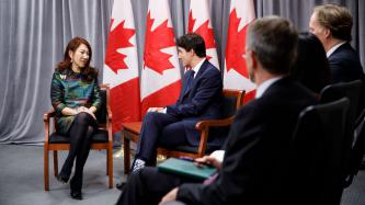 PM Trudeau sits and speaks with CEO Wei Sun Christianson