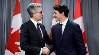 PM Trudeau shakes hands with CEO Bill McDermott
