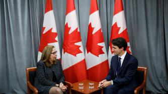PM Trudeau sits and listens to CEO Afsaneh Beschloss