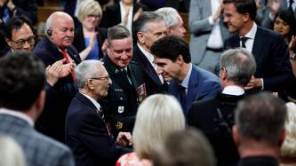 PMs Trudeau and Rutte shake hands with veterans