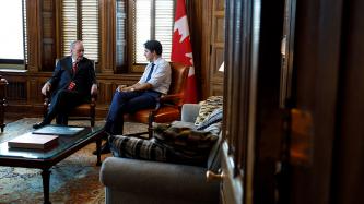 PM Trudeau sits and talks with former PM Jean Chretien