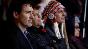 PM Trudeau, Mayor Spence and Grand Chief Dumas sit and watch