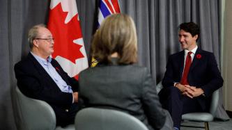PM Trudeau sits and talks with Mayor McCallum