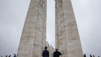 PM Trudeau and a military personnel pay their respects